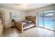 Bedroom with pool access and a king-size bed at 1705 Fredricksburg Ave, Lakeland, FL 33803