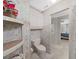 Clean bathroom with toilet, shelves, and access to another room at 1716 Quail Hill Dr, Lakeland, FL 33810
