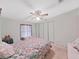 Bright bedroom featuring a ceiling fan and double closets at 1716 Quail Hill Dr, Lakeland, FL 33810