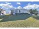Single-wide manufactured home with carport and landscaped yard at 1716 Quail Hill Dr, Lakeland, FL 33810
