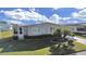 Single-wide manufactured home with carport and landscaped yard at 1716 Quail Hill Dr, Lakeland, FL 33810