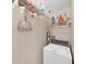 Laundry room with washer, shelving for storage, and cleaning supplies at 1716 Quail Hill Dr, Lakeland, FL 33810