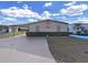 Tan mobile home with carport and well-manicured landscaping at 1750 Fox Hill Dr, Lakeland, FL 33810