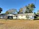 White house with a spacious front yard at 1865 4Th Se St, Winter Haven, FL 33880