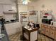 Galley kitchen with white cabinets and kitchen island at 1865 4Th Se St, Winter Haven, FL 33880