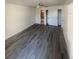 Bedroom with wood-look floors and access to bathroom at 19 Aspen Dr. # 19, Haines City, FL 33844
