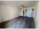 Bedroom with wood-look floors and access to bathroom at 19 Aspen Dr. # 19, Haines City, FL 33844