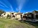Light beige condo building with stone accents and landscaping at 19 Aspen Dr. # 19, Haines City, FL 33844
