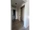 Hallway with closet and bathroom access, featuring hardwood floors at 19 Aspen Dr. # 19, Haines City, FL 33844