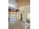 Open living room with high ceiling, wood floors, and access to patio at 19 Aspen Dr. # 19, Haines City, FL 33844
