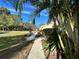 Sidewalk view of condo building and tropical plants at 19 Aspen Dr. # 19, Haines City, FL 33844