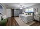 Main bedroom with wood floors, sliding barn door, and a comfy bed at 2104 John Arthur Way, Lakeland, FL 33803
