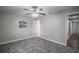Well-lit bedroom with neutral walls, plush carpeting, and ceiling fan at 2104 John Arthur Way, Lakeland, FL 33803