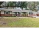 Ranch house with brick facade and landscaping at 2104 John Arthur Way, Lakeland, FL 33803