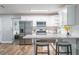 Modern kitchen with white cabinets, granite countertops, and stainless steel appliances at 2104 John Arthur Way, Lakeland, FL 33803