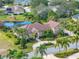 Aerial view of a beautiful home with a swimming pool and meticulously landscaped grounds at 221 Mclean Pt, Winter Haven, FL 33884