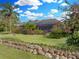 Landscaped backyard with pool and lush gardens at 221 Mclean Pt, Winter Haven, FL 33884