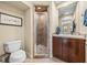 Cozy bathroom offers a tiled walk-in shower, tiled floors, and vanity with a sink at 221 Mclean Pt, Winter Haven, FL 33884