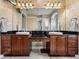 Bathroom showcasing dual sinks with dark countertops and a large mirror with decorative lighting at 221 Mclean Pt, Winter Haven, FL 33884