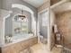 Bathroom featuring a soaking tub, a shower with a rainfall showerhead, and toilet at 221 Mclean Pt, Winter Haven, FL 33884