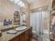 Inviting bathroom with decorative tilework, granite countertop vanity, and shower-tub combo at 221 Mclean Pt, Winter Haven, FL 33884