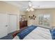 Bright bedroom with closet, window with plantation shutters, and dresser with TV at 221 Mclean Pt, Winter Haven, FL 33884