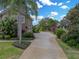 Brick driveway and lush landscaping leading to the home at 221 Mclean Pt, Winter Haven, FL 33884