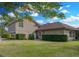 Home's side yard with lush landscaping and lawn at 221 Mclean Pt, Winter Haven, FL 33884