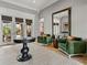 Stylish foyer with a dark wood accent table and a light colored area rug at 221 Mclean Pt, Winter Haven, FL 33884