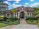 Charming home featuring a well-maintained lawn, beautiful landscaping, and a paver walkway at 221 Mclean Pt, Winter Haven, FL 33884