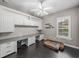 Home office boasts built-in cabinets, a large window, and dark wood floors at 221 Mclean Pt, Winter Haven, FL 33884