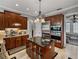 Open-concept kitchen features custom island, granite counters and stainless steel appliances at 221 Mclean Pt, Winter Haven, FL 33884