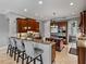 Modern kitchen with granite countertops, stainless steel appliances, and a breakfast bar at 221 Mclean Pt, Winter Haven, FL 33884