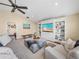 Cozy living room featuring built-in media center, plush furniture, and ample natural light at 221 Mclean Pt, Winter Haven, FL 33884