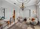 Comfortable living room featuring elegant chandelier and soft neutral tones at 221 Mclean Pt, Winter Haven, FL 33884