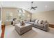 Inviting living room featuring a large sectional, hardwood floors, and large windows at 221 Mclean Pt, Winter Haven, FL 33884