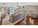 Spacious living room with hardwood floors, built-in shelving, large windows, and vaulted ceiling at 221 Mclean Pt, Winter Haven, FL 33884