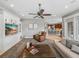 Open-concept living room showcasing a fireplace and flowing into the kitchen and dining area at 221 Mclean Pt, Winter Haven, FL 33884