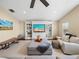 Spacious living room with a media center, comfortable seating, and large windows at 221 Mclean Pt, Winter Haven, FL 33884