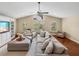 Bright living room with large sofa, hardwood floors, expansive windows with views of the outdoors at 221 Mclean Pt, Winter Haven, FL 33884