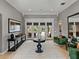 Living room featuring a rug, table and chairs, with views to the backyard at 221 Mclean Pt, Winter Haven, FL 33884