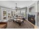 Spacious living room features fireplace, ceiling fan, and large windows with natural lighting at 221 Mclean Pt, Winter Haven, FL 33884