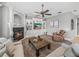 Cozy living room with a fireplace, custom shelving, and a comfortable seating area at 221 Mclean Pt, Winter Haven, FL 33884