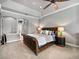 Comfortable primary bedroom with a leather sleigh bed, tray ceilings and carpeted floor at 221 Mclean Pt, Winter Haven, FL 33884