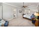 Spacious main bedroom with a ceiling fan, TV, and a door to a private outdoor space at 221 Mclean Pt, Winter Haven, FL 33884