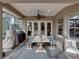 Covered outdoor dining area with a rustic wooden table, benches, a ceiling fan, and a view of the yard at 221 Mclean Pt, Winter Haven, FL 33884