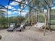 The backyard patio features comfortable lounge chairs, a swing, and views of the surrounding landscape at 221 Mclean Pt, Winter Haven, FL 33884