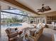 Screened patio offers a ceiling fan, comfortable seating, and views of the in-ground pool at 221 Mclean Pt, Winter Haven, FL 33884
