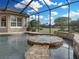 The pool features a built-in spa and stone accents, creating a tranquil and luxurious swimming experience at 221 Mclean Pt, Winter Haven, FL 33884