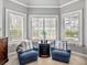 Inviting sitting area with comfortable blue chairs and natural light from the windows at 221 Mclean Pt, Winter Haven, FL 33884